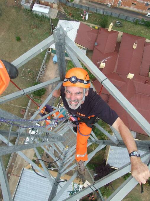 As a working from heights specialist, Mr Hanson was uniquely qualified to put Christmas lights on the Telstra Tower at his old hometown of Bingara. Picture supplied by Geoff Hanson