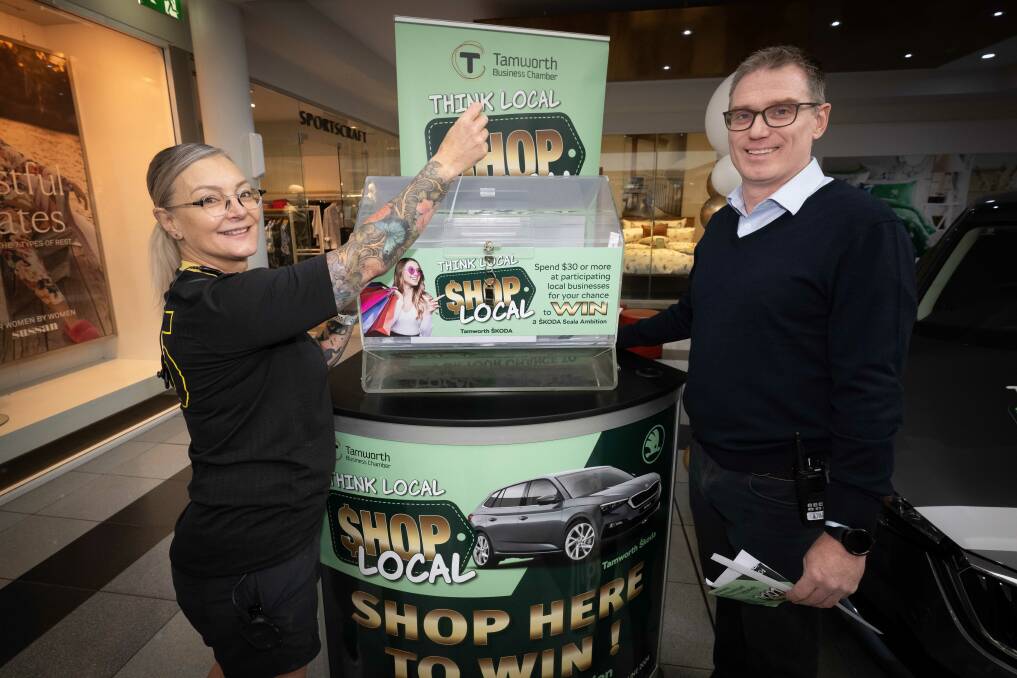 Rebel Sports' Tracey Lunam and Centrepoint manager Martin Howes draw the first name to potentially win a new car. Picture by Peter Hardin