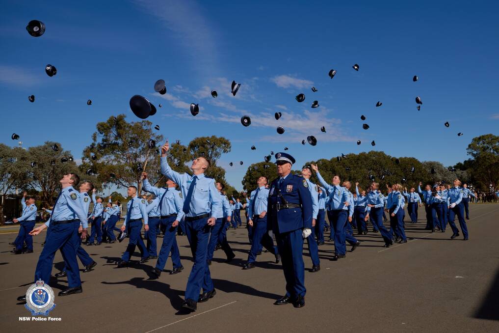More than 220 new recruits threw their hats in the air at an attestation parade to graduate from the Goulburn Police Academy on Friday. Picture supplied by NSW Police