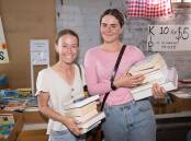 Ashleigh Aitken and Shaelynn Hernando happily carried out an armload of books each from the annual Lions Giant Book Sale on Sunday, November 5. Picture by Peter Hardin