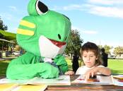 HIPPY mascot, Flip Flop the Frog, helps current HIPPY youngster Jaxon Webster learn to sound out words. Picture by Peter Hardin
