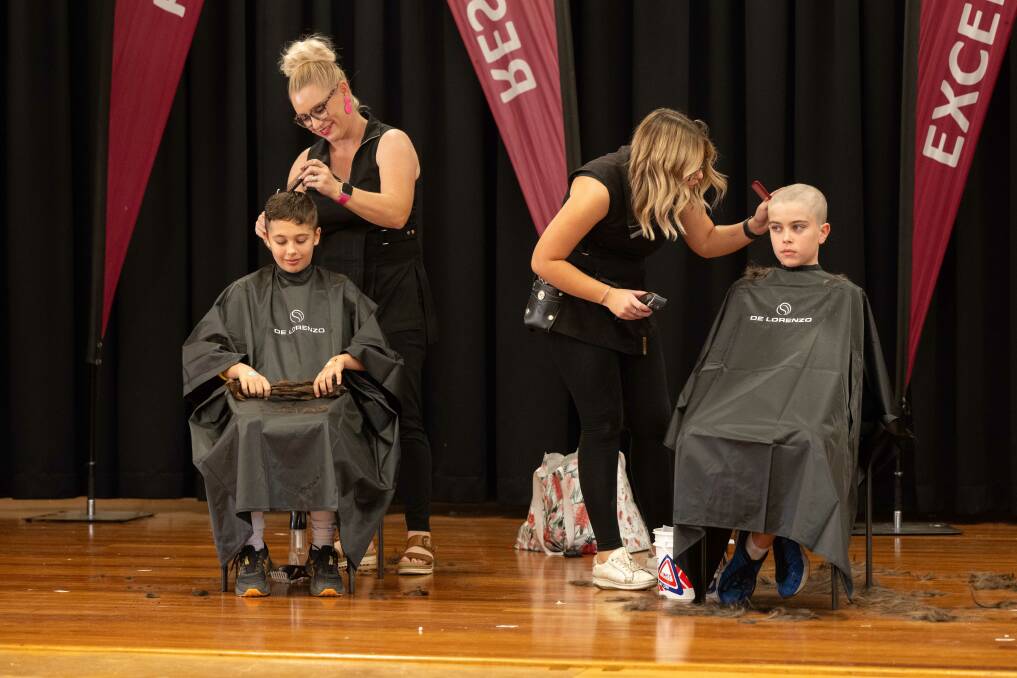 The big chop happened in the school hall, Harrison did the clean shave, while Nina cut her hair short to help make wigs for kids with cancer. Picture by Peter Hardin