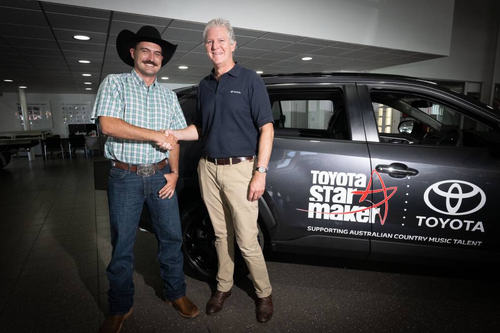 Wade Forster and Toyota Australia senior manager of marketing integration Tim Stuckey hand over the keys to Wade's new car. Picture by Peter Hardin. 