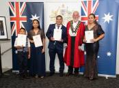 Dwell, Dwelleth, Rodel, and Lourdes Rimandiman receive their Australian citizenship certificates from Tamworth mayor Russell Webb. Picture by Peter Hardin 