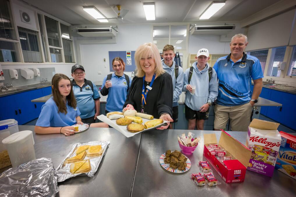 Katelyn Bruce, Jesyha Johns, Lily Young, student support officer Sue Warden, brothers Brendan and Joshua Thompson, and head teacher wellbeing Steve Lasscock enjoy the Tamworth High Breakfast Club. Picture by Peter Hardin