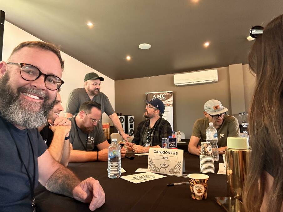 Cameron Hayton from Walcha Coffee watches category judges Paul Asquith (sitting), Ben Gleeson (standing), Michael Brennan (black hat) and Brian Cole at work during the Australasian Golden Bean Awards. Picture supplied 