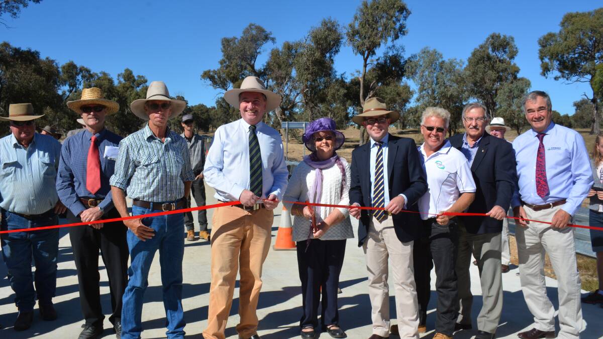 Guyra Citizen of the Year Dot Vickery, centre, wields the big pair of scissors today to officially cut the ribbon on the new Tenterden Bridge with Member for New England Barnaby Joyce and Northern Tablelands MP Adam Marshall.