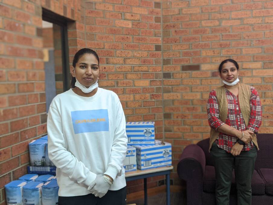 Sisters Lakhwinder Kaur and Gurinderjit Kaur in the Queanbeyan community hall where the hampers are made up. Picture: Megan Doherty.
