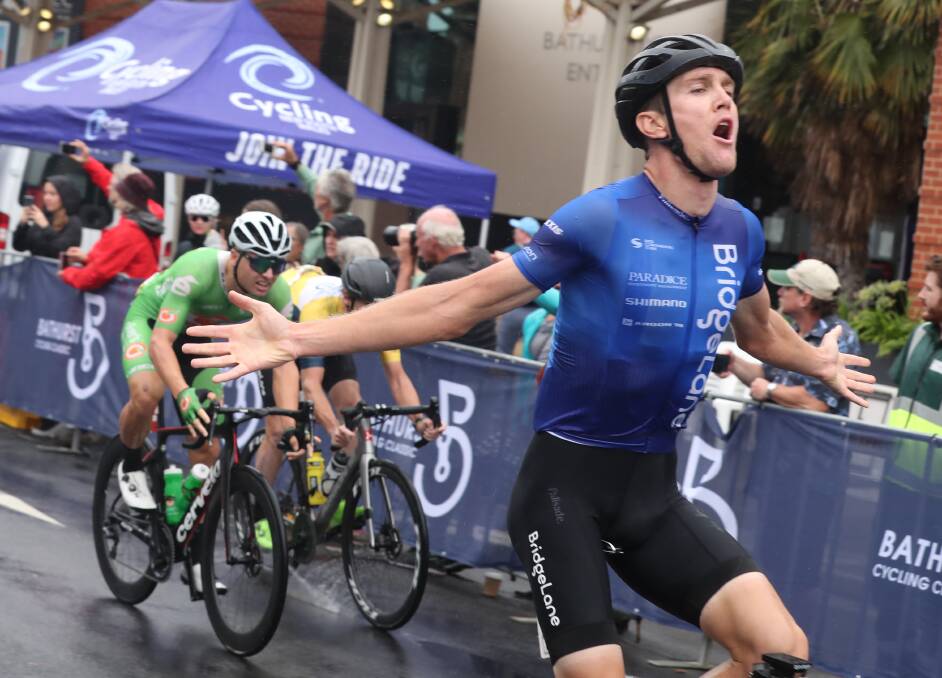 THREE-PEAT: Sam Hill shows his elation as he crosses the finish line to win his third consecutive Bathurst Cycling Classic men's road race on Sunday. Photo: Phil Blatch