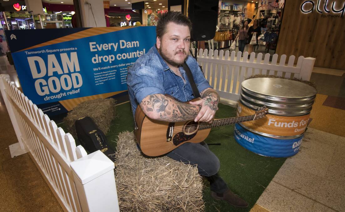 Singing along: Jarred Taylor sings for drought relief at Tamworth Square. Photo: Peter Hardin 130918PHC019