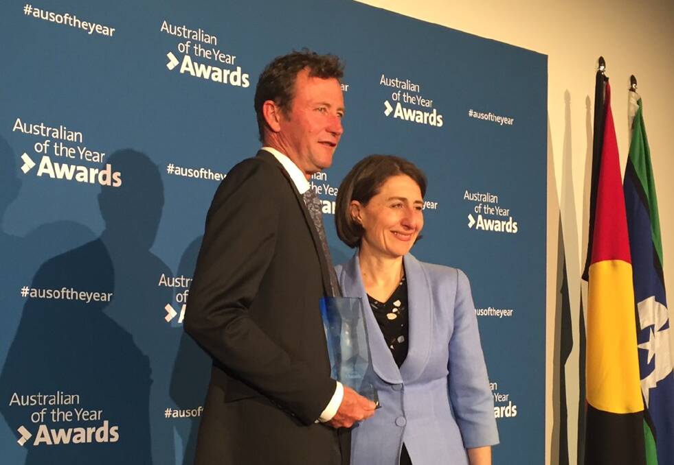 Bernie Shakeshaft receives his award from Premier Gladys Berejiklian in Sydney on Monday night. 