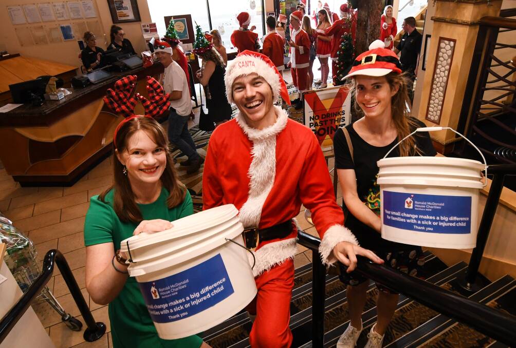 Gift of giving: Marina Laurence, Chris Watson and Naomi Blakey raising money for Ronald McDonald House. Photo: Gareth Gardner 141218GGG02