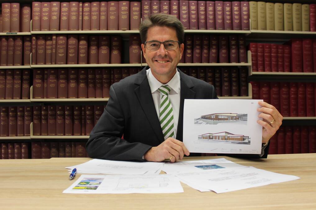 Budget bonus: Member for Tamworth Kevin Anderson with the plans for work at Farrer Memorial Agricultural High School.