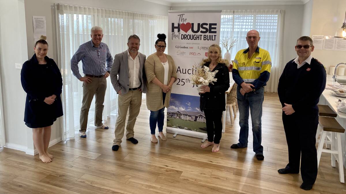 All smiles: Amy Hughes (PRD Tamworth), Dean Cummins (PRD Tamworth), Daniel and Natalie Urquhart (G.J. Gardner Homes Tamworth), Cathy and Brian Crowe (Homebuyers), and Captain Brad McIver (The Salvation Army) after Saturday's auction. Photo: Supplied.