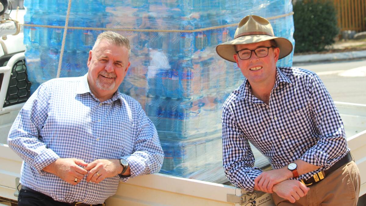Off tap: Uralla Mayor Michael Pearce and Member for Northern Tablelands Adam Marshall in front of part of the load of bottled water delivered to Uralla last week.

