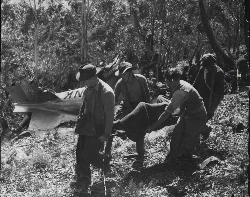Above: Bodies being removed from the Lutana crash site.