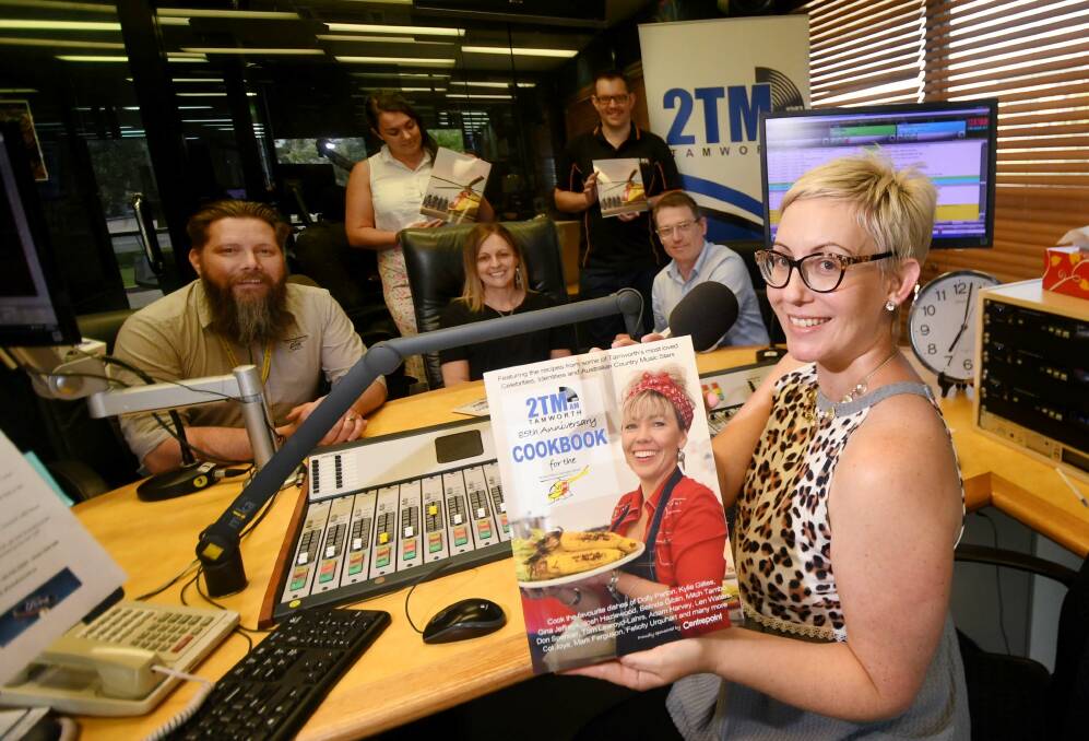 GET COOKING: Sally-Anne Whitten shows off a new cookbook, launched by radio station 2TM for the station's 85th anniversary. Photo: Gareth Gardner