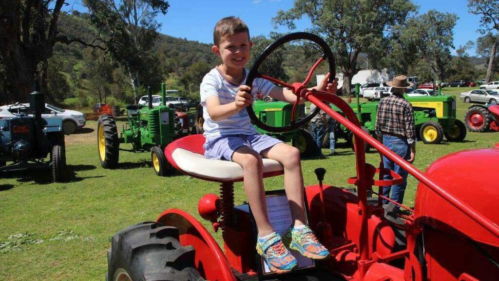 Drive time: Henry Haling on a Farmall Cub at the Rotary Dungowan Village Fair and Motor Show on the weekend.