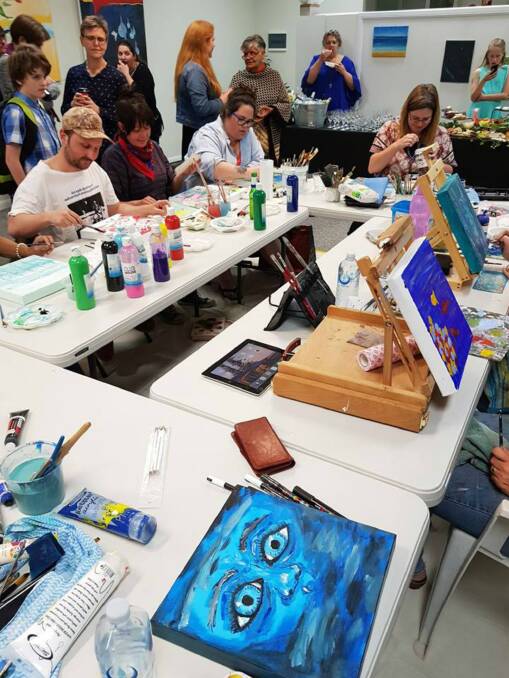 Artists working on their creations at a speed painting event in october 2019.
