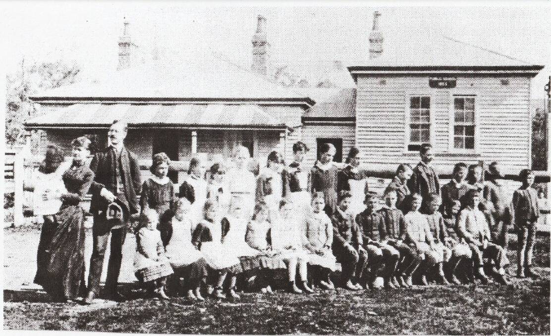 Old school yard: Gowrie School, one of the great little Bush Schools in the Tamworth district that no longer operate, pictured here in 1922. The teacher David Rynd with wife and child on the left. Photo: Supplied