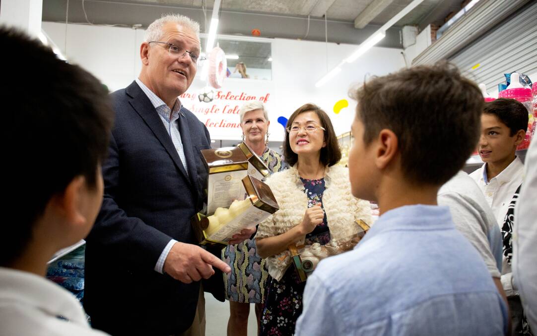 Campaign trail: Prime Minister Scott Morrison visits Wallies Lollies in Box Hill South with Gladys Liu in the electorate of Chisolm in Melbourne. Photo: James Croucher