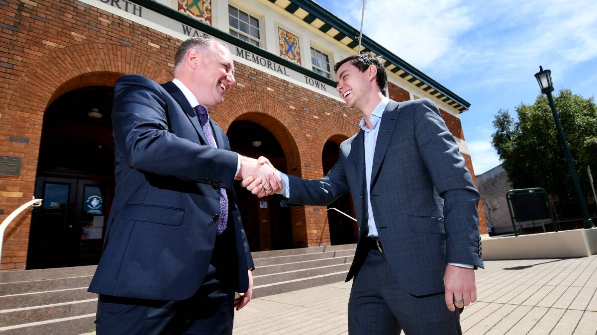 Shake on it: Tamworth Business Chamber president Jye Segboer and NSW Business Chamber's Joe Townsend join forces to lower electricity costs. Photo: Gareth Gardner 
