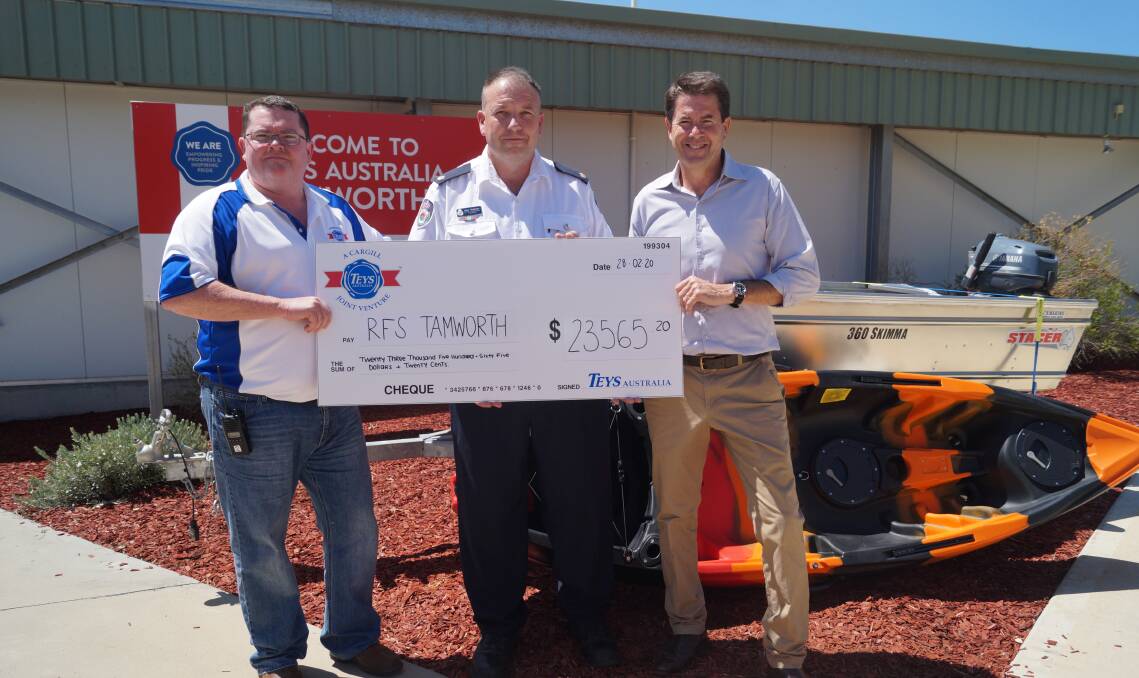 Big thanks: Michael Wells, General Manager Operations, presents the cheque to Michael Robinson from the Tamworth Rural Fire Service, with Tamworth MP Kevin Anderson. Photo: Supplied.