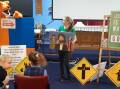 Lots of fun: Quiz Word visited the weekly Kootingal Kids Club. Larissa warns Sherbie not to miss the signs along the way. Photo: Supplied