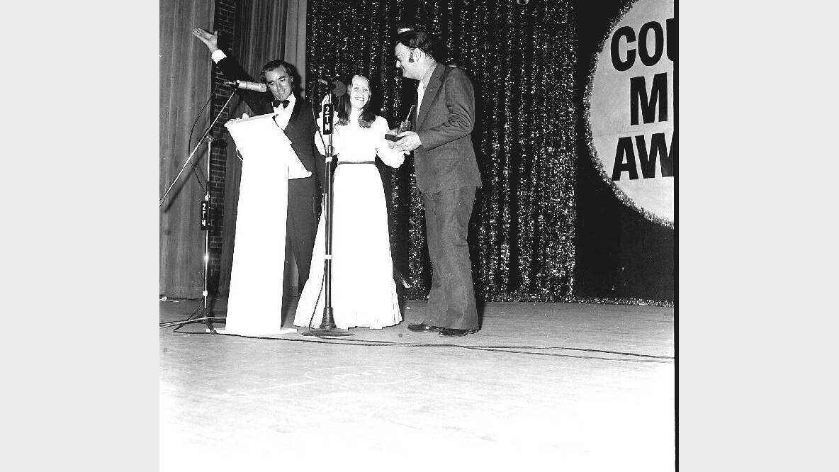 Possibly the third Awards (1975), where Kevin Knapp salutes, left, as Suzanne Prentice presents Nev Nicholls with the Best Instrumental Award (Nashville Express).