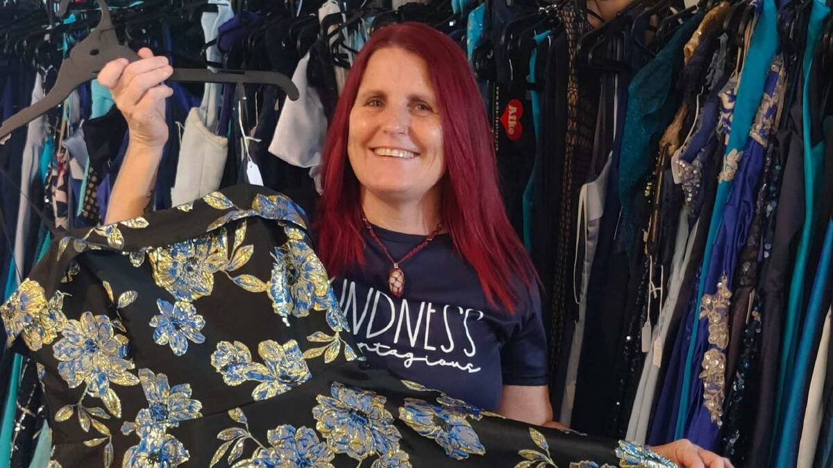 Founder of Formally Ever After, Tammy Robinson shows one of the hundreds of formal dresses she has amassed. Picture supplied. 