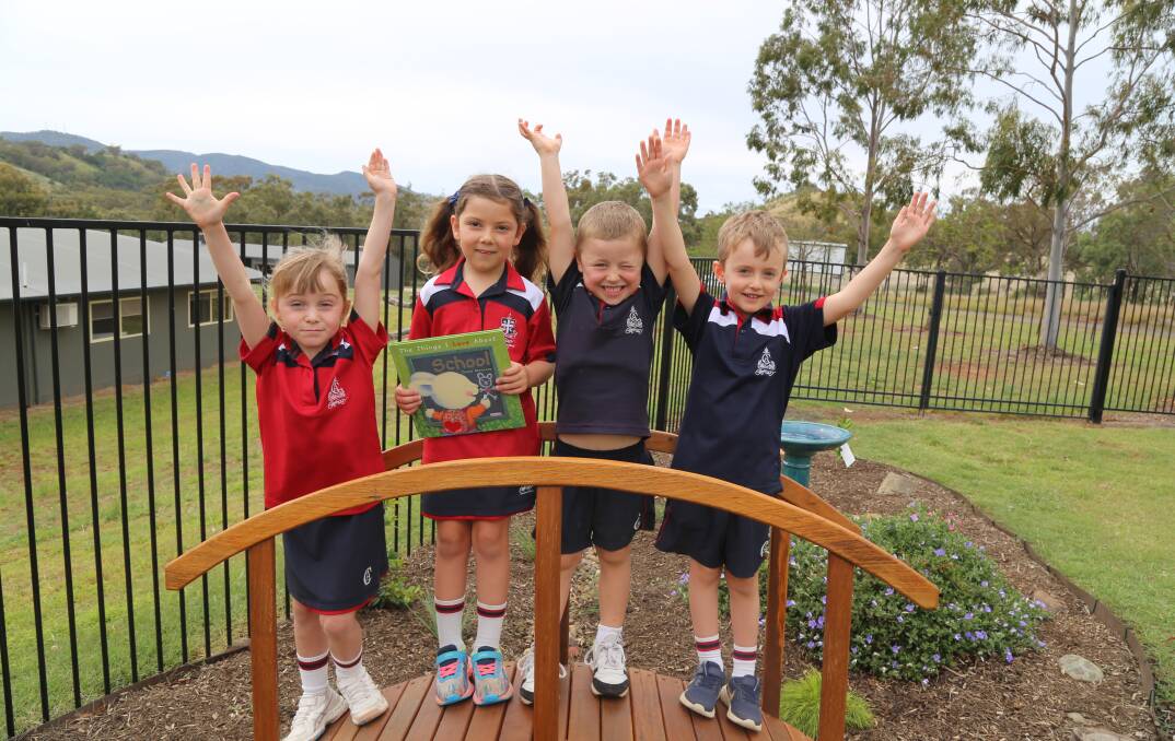 Hands up: Calrossy's youngest students in Prep celebrate their much loved teachers on World Teachers' Day from left, Annabel Rivers, Indiana Moujalli, Boston Walker and Henry Campbell. Photo: Supplied.
