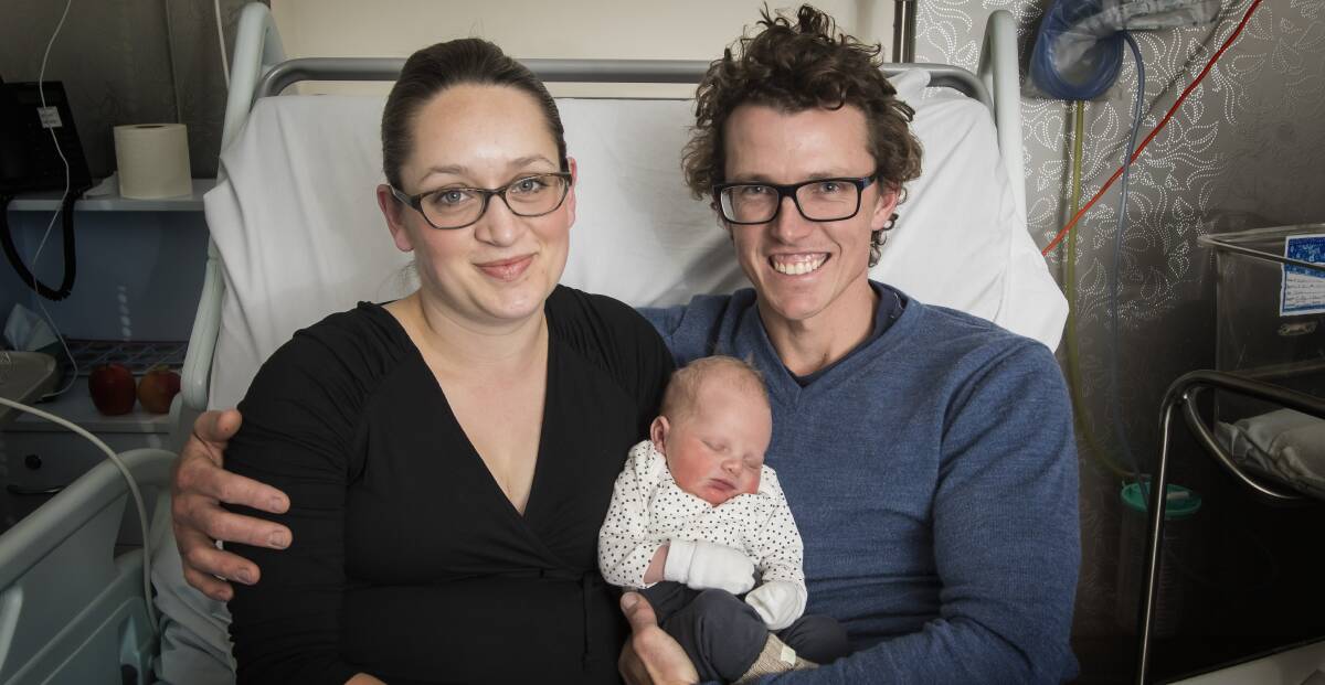 SO CLOSE: Brydie and Ben Frazer with their son Arlo, who was a few days shy of being the nation's 25 millionth citizen. Photo: Peter Hardin