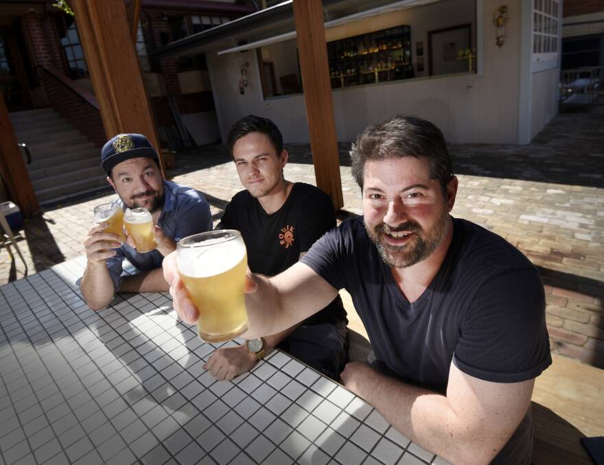 CHEERS: Luke Prout, Alex Nicholls and Dan Whitten are preparing to show of the hotel's new beer garden for it's historic celebration this weekend. Photo: Gareth Gardner
