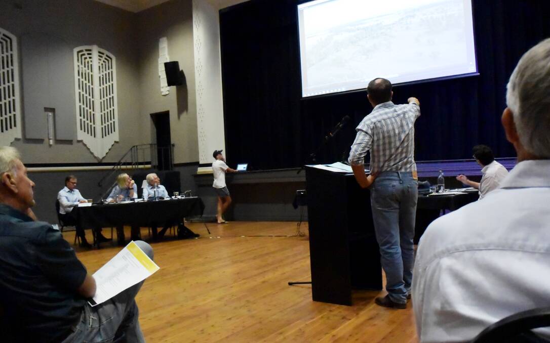 HEARING: Farmer Grant Mcilveen uses drone footage and a laser pointer to show where the proposed mine site lies in relation to the river and nearby farms.