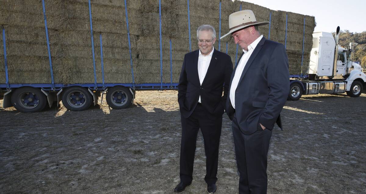 DROUGHT SUMMIT: Scott Morrison and Barnaby Joyce in front of a truck packed with hay. Photo: Alex Ellinghausen