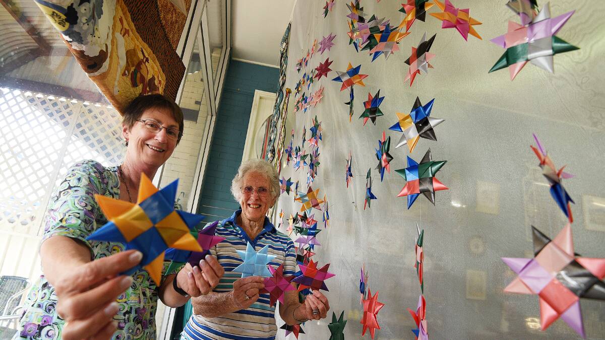 SHINE BRIGHT: Leonie Bell and Ann Crosby with the ribbon star display at Inspirations Cafe, which will soon be shipped to Queensland for the Commonwealth Games. Photo: Gareth Gardner 090317GGE01