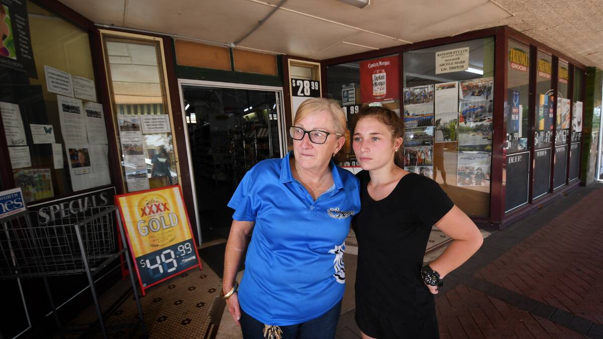 NO RECEPTION: Ros Marr and Lilly-May Neal, out the front of Friendly Grocers, one of many businesses to be left without service. Photo: Gareth Gardner 311218GGC02