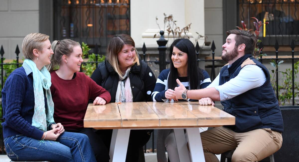BIG AND BETTER: Em Sims, Sarah Hetherington, Tayla Maloney, Kate Miles and Tom McDouall planning the new look ball. Photo: Gareth Gardner