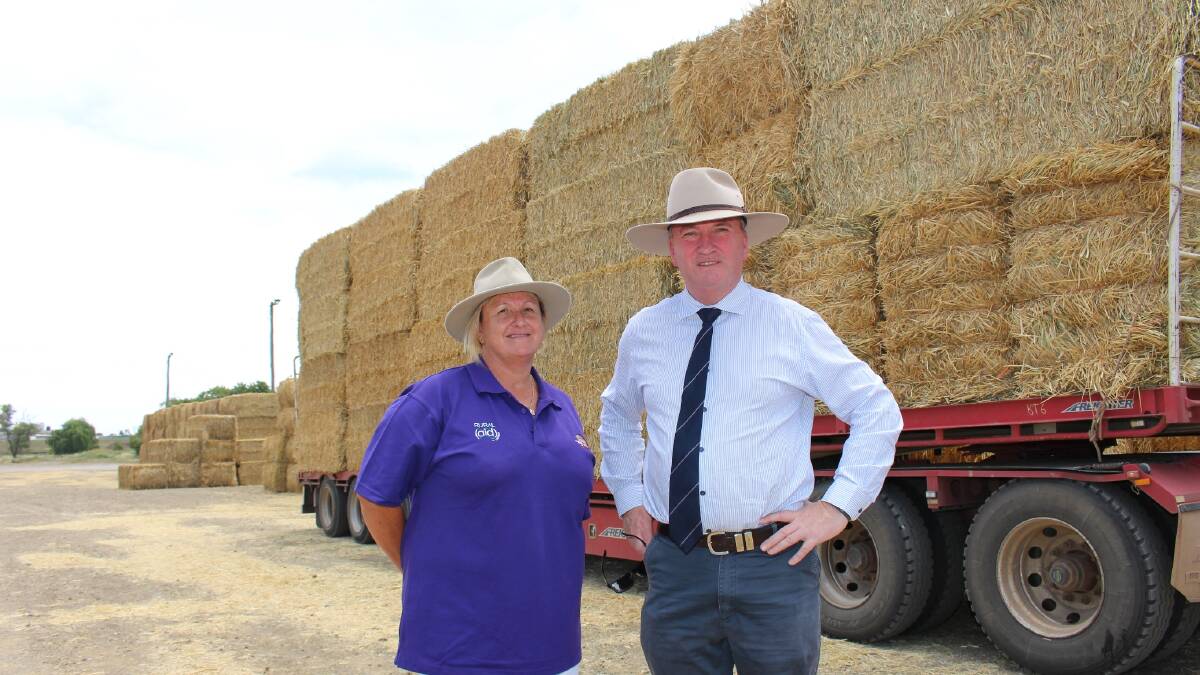 BIG LOAD: Tracey Alder and Barnaby Joyce with one of the 30 hay trucks to roll in to town.
