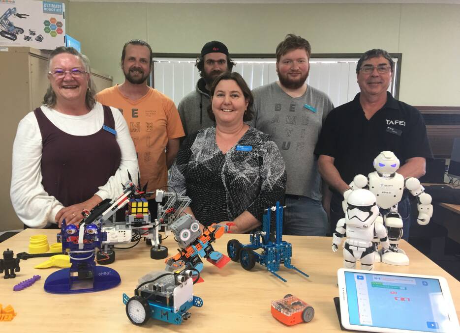 HANDS ON: Pene Cracknell, Anthonee Williams, Jason Fraser, Jackie Sheehan, Nathanael Barr and Rob Beaney with some of the robots that will be on display.