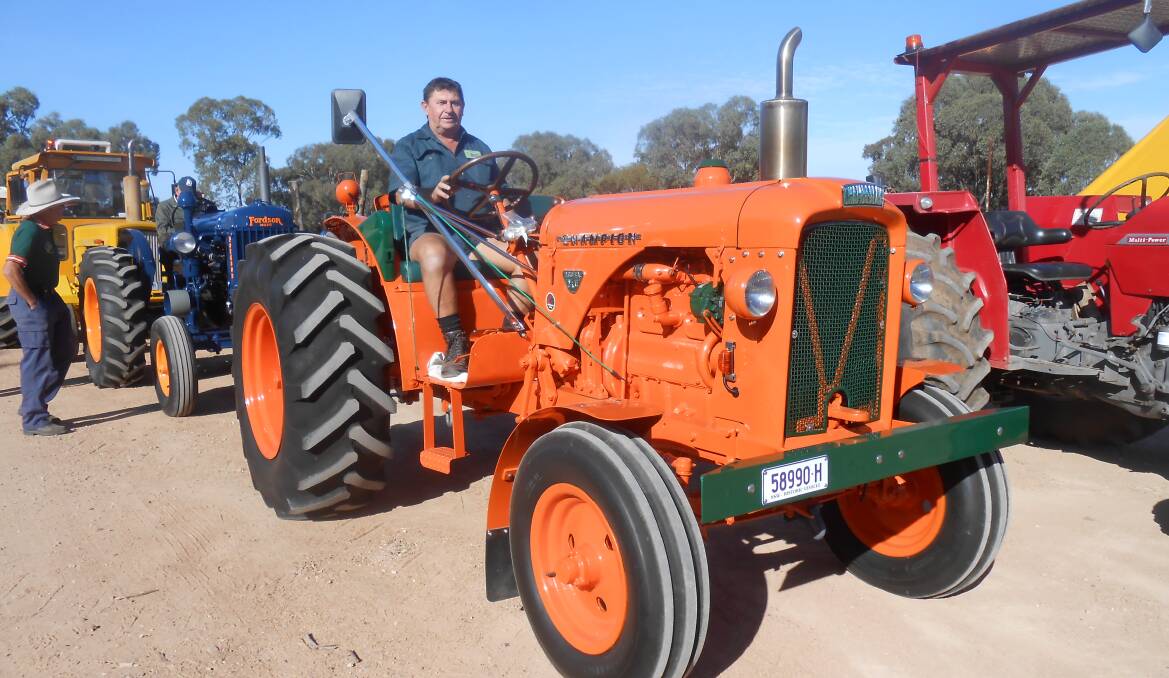 LOUD AND PROUD: George Proctor from Eungai Creek on his big orange tractor. He'll be part of the Quirindi Rural Heritage Village's tractor convey.