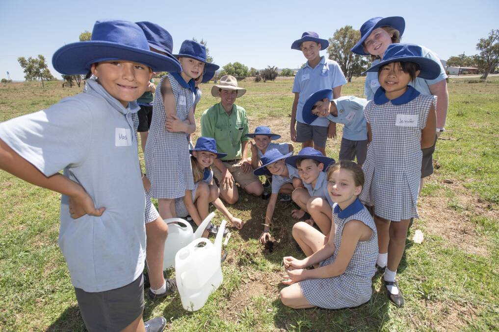 WORKPLACE READY: A Peel High School student teachers primary school kids how to propogate and plant native trees. Photo: Peter Hardin