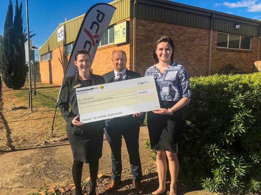 LAUGHING TO THE BANK: Gunnedah Commonwealth branch manager Elizabeth Algie presents the cheque to Stephen Lewin, and Youth Insearch leader Ramona Lee.