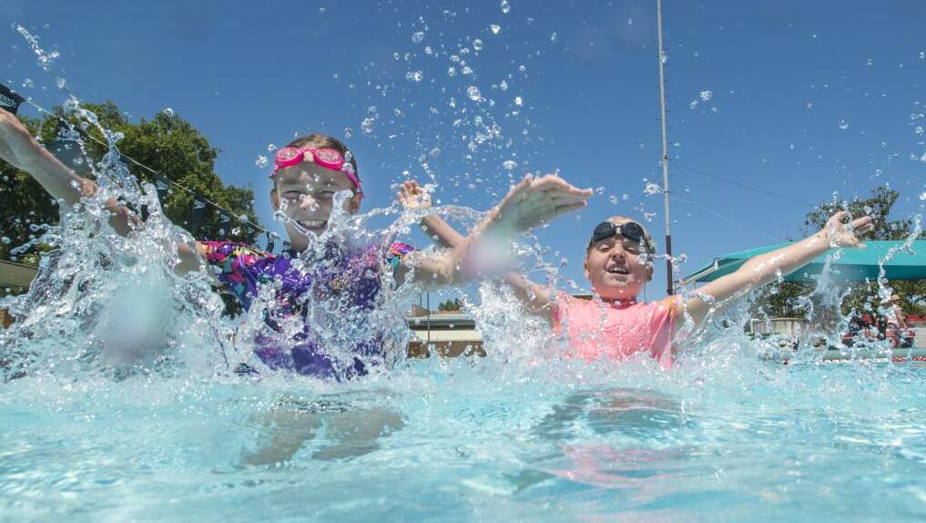 BEAT THE HEAT: Mia Robinson and Ellie Webster escape the warm water in the cool waters of Tamworth City Pool. Photo: Peter Hardin