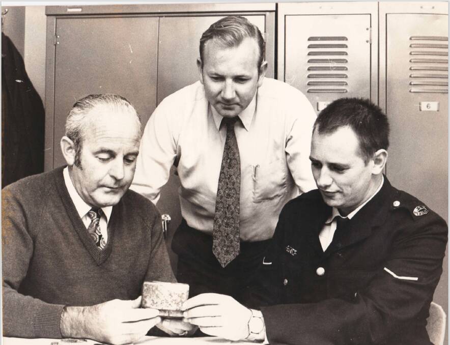 Evidence: Police Max Jacobson, John Ure and Eddie Gill examine the tobacco tin. 