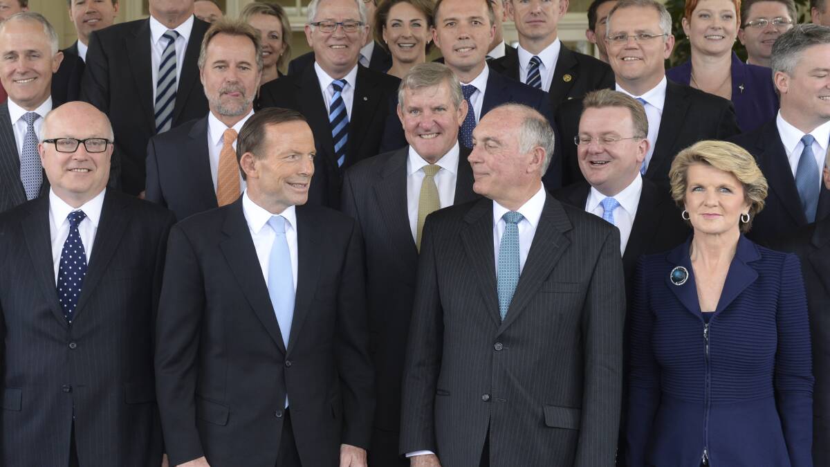Prime Minister Tony Abbott, (second from left) smiles at Foreign Minister Julie Bishop, right, the only woman in the senior ministry in 2013. Picture AAP
