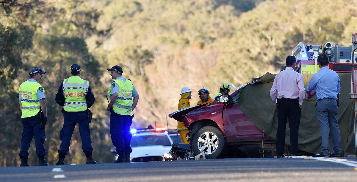 HIGHWAY HORROR: Police and New England detectives at the scene of the head-on collision south of Uralla, which killed two men. Photo: Gareth Gardner