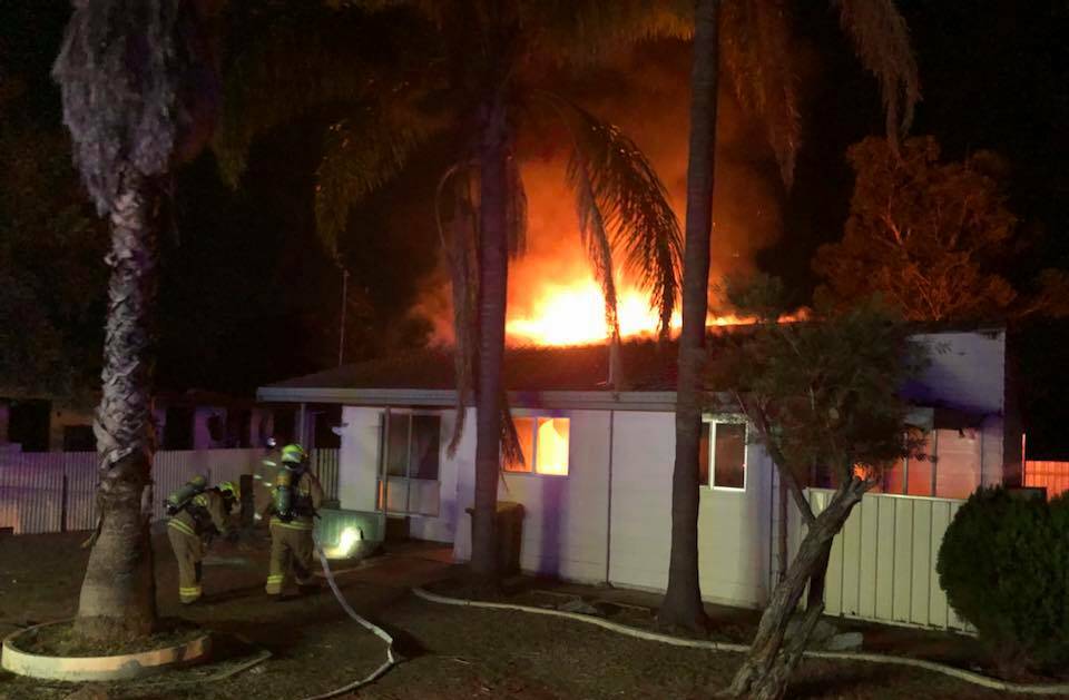 Crime scene: Firefighters work to douse the blaze in the Kenny Drive house in Coledale, Tamworth. Photo: Fire and Rescue NSW