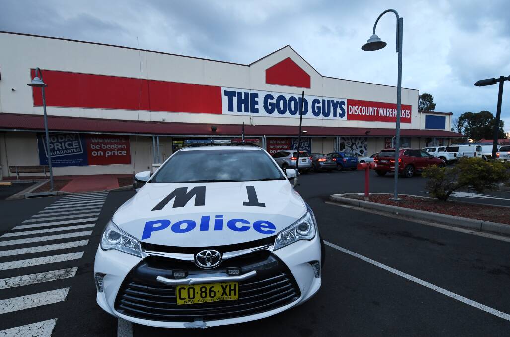 Crime scene: Police and detectives at the store in the Longyard area on Thursday afternoon. Photos: Gareth Gardner
