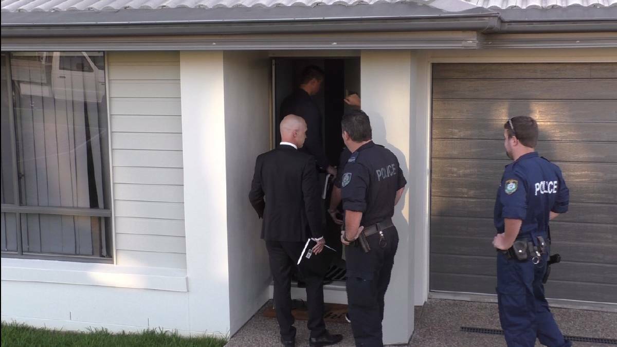 Rolling raids: New England officers from Strike Force Janian at a raid on an Armidale home in December as part of the massive police operation. Photo: NSW Police